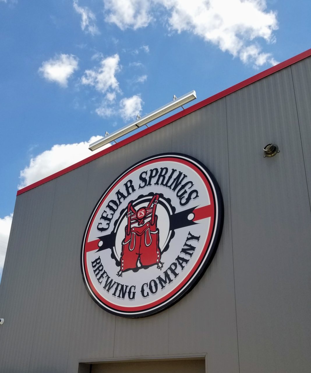 who owns hop springs brewery